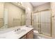 Bathroom featuring a shower with gold trim, neutral walls, large mirror and tile floors at 1700 E Lakeside Dr # 64, Gilbert, AZ 85234