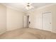 Empty bedroom featuring neutral carpeting, a ceiling fan, and ample closet space at 1700 E Lakeside Dr # 64, Gilbert, AZ 85234