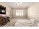 Bedroom with carpeted floors, a ceiling fan and a tv stand, with access to the back patio at 1700 E Lakeside Dr # 64, Gilbert, AZ 85234
