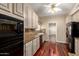 Bright kitchen with warm wood floors, granite counters, and a suite of modern, black appliances at 1700 E Lakeside Dr # 64, Gilbert, AZ 85234