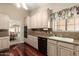 Kitchen with stainless steel appliances, granite countertops and wood-look flooring and light colored cabinets at 1700 E Lakeside Dr # 64, Gilbert, AZ 85234