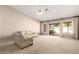 Bright living room featuring neutral carpet, white leather furniture and sliding glass doors to the backyard at 1700 E Lakeside Dr # 64, Gilbert, AZ 85234