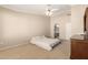 Spacious main bedroom with neutral tones, ceiling fan, ensuite bathroom, and large walk in closet at 1700 E Lakeside Dr # 64, Gilbert, AZ 85234
