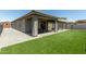 Backyard with artificial grass, a covered patio, and an additional seating area at 17219 W Gibson Ln, Goodyear, AZ 85338