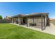 Inviting backyard featuring an extended patio, pergola, and lush artificial grass for easy maintenance at 17219 W Gibson Ln, Goodyear, AZ 85338