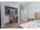 Bedroom with organized closet, neutral walls, and a side table at 17219 W Gibson Ln, Goodyear, AZ 85338