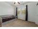 Bright bedroom with a daybed, carpet, and two large windows that provide plenty of natural light at 17219 W Gibson Ln, Goodyear, AZ 85338