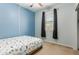 Bright bedroom with a large window, ceiling fan and comfortable bedding at 17219 W Gibson Ln, Goodyear, AZ 85338