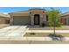 Charming single-story home with desert landscaping and a two-car garage at 17219 W Gibson Ln, Goodyear, AZ 85338