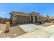 Attractive home featuring desert landscaping and a convenient two-car garage at 17219 W Gibson Ln, Goodyear, AZ 85338