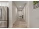 Inviting hallway featuring wood-look flooring, leading to a bright and open living space at 17219 W Gibson Ln, Goodyear, AZ 85338