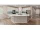 Bright and modern kitchen featuring white cabinets, quartz countertops, and a center island at 17219 W Gibson Ln, Goodyear, AZ 85338