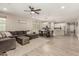 Open-concept living area with wood-look flooring that connects to the dining area and kitchen at 17219 W Gibson Ln, Goodyear, AZ 85338