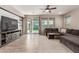 Comfortable living room with wood-look floors, a large sectional sofa, and a backyard view at 17219 W Gibson Ln, Goodyear, AZ 85338