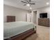 Bright main bedroom with carpet, neutral colors, a ceiling fan, TV and two dressers providing ample storage space at 17219 W Gibson Ln, Goodyear, AZ 85338