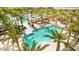Aerial view shows palm trees surrounding a pool area that offers relaxing lounge chairs and a serene atmosphere at 17279 W Dartmouth St, Surprise, AZ 85388