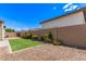 Backyard with artificial turf, desert landscaping, and block wall provides privacy at 17279 W Dartmouth St, Surprise, AZ 85388