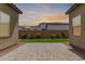 Backyard with artificial turf, colorful flowers, and block wall fencing for privacy at 17279 W Dartmouth St, Surprise, AZ 85388