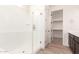 Modern bathroom featuring glass-enclosed shower and walk-in closet at 17279 W Dartmouth St, Surprise, AZ 85388