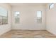 Bright bedroom with wood-style tile flooring and multiple windows at 17279 W Dartmouth St, Surprise, AZ 85388