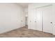 Bedroom featuring wood-style tile flooring and sliding closet doors at 17279 W Dartmouth St, Surprise, AZ 85388