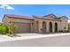 Charming single-story home with a two-car garage, arched entryway, and red tile roof at 17279 W Dartmouth St, Surprise, AZ 85388