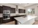 Stylish kitchen with quartz countertops, stainless steel appliances, and a center island at 17279 W Dartmouth St, Surprise, AZ 85388