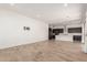 Open-concept living area with modern kitchen, recessed lighting, and bright tile flooring at 17279 W Dartmouth St, Surprise, AZ 85388