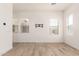 Bright living room with wood-style tile flooring, neutral walls, and lots of natural light at 17279 W Dartmouth St, Surprise, AZ 85388