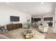 Open-concept living area with modern decor, a kitchen island, and tile flooring at 17279 W Dartmouth St, Surprise, AZ 85388