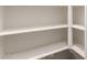Walk-in pantry with white painted shelves, offering ample storage space at 17279 W Dartmouth St, Surprise, AZ 85388