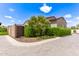 Landscaped yard featuring a privacy fence, mature trees, and desert foliage at 17279 W Dartmouth St, Surprise, AZ 85388