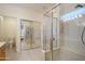 Bright bathroom featuring a glass-enclosed shower and separate soaking tub at 17371 N Natura Trl, Surprise, AZ 85374