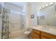 Bright bathroom with tub and shower combo and a wood vanity with marble counter at 17371 N Natura Trl, Surprise, AZ 85374