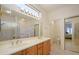 Spacious bathroom with double sinks, tiled flooring, and a large mirror above vanity at 17371 N Natura Trl, Surprise, AZ 85374