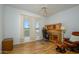 Bedroom with hardwood floors, ceiling fan, and a cozy desk and chair at 17371 N Natura Trl, Surprise, AZ 85374