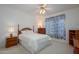 Bedroom featuring a bed, nightstands, dresser and decoratively curtained window at 17371 N Natura Trl, Surprise, AZ 85374