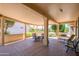 Spacious covered patio with ample seating and views of the well-manicured yard at 17371 N Natura Trl, Surprise, AZ 85374