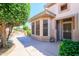 Welcoming single-story home with a screened in bay window and mature front landscaping at 17371 N Natura Trl, Surprise, AZ 85374