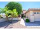 Inviting single-story home featuring mature trees and shrubs to frame the facade at 17371 N Natura Trl, Surprise, AZ 85374