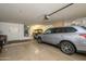 Garage with car and golf cart with garage door opener and built-in storage at 17371 N Natura Trl, Surprise, AZ 85374