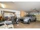 Garage with an SUV and golf cart, offering ample space for vehicles and storage at 17371 N Natura Trl, Surprise, AZ 85374