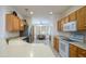 Well-lit kitchen with stainless steel appliances, light wood cabinetry, and a view of the dining area at 17371 N Natura Trl, Surprise, AZ 85374