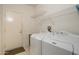 Laundry room with washer and dryer with wire shelving for added storage at 17371 N Natura Trl, Surprise, AZ 85374