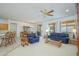 Spacious living area with a ceiling fan and seamless flow into the dining room and kitchen at 17371 N Natura Trl, Surprise, AZ 85374