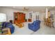 Bright living room featuring hardwood furniture and a view of the kitchen area at 17371 N Natura Trl, Surprise, AZ 85374