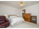 Bright main bedroom featuring plush carpeting, a ceiling fan and a large window at 17371 N Natura Trl, Surprise, AZ 85374