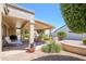 Comfortable covered patio area perfect for relaxing and entertaining, with manicured landscaping at 17371 N Natura Trl, Surprise, AZ 85374