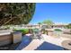 Charming outdoor seating area perfect for entertaining and relaxation, complete with lush greenery at 17371 N Natura Trl, Surprise, AZ 85374