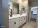 Well-lit bathroom with dual sinks, modern vanity, large mirrors, and stylish finishes, creating a spa-like feel at 17482 W Fulton St, Goodyear, AZ 85338